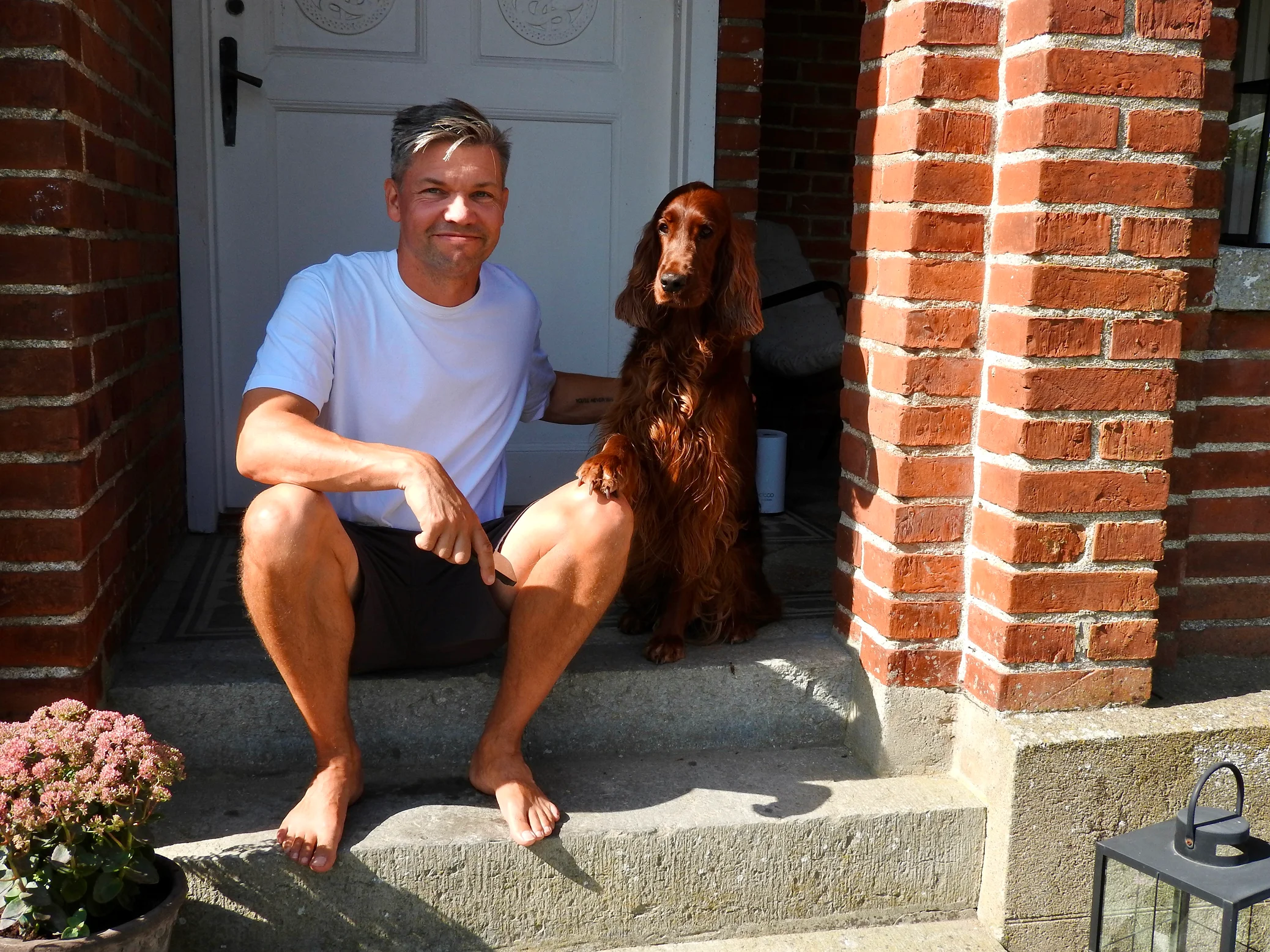 Anton with Taylor and our house in the Swedish countryside